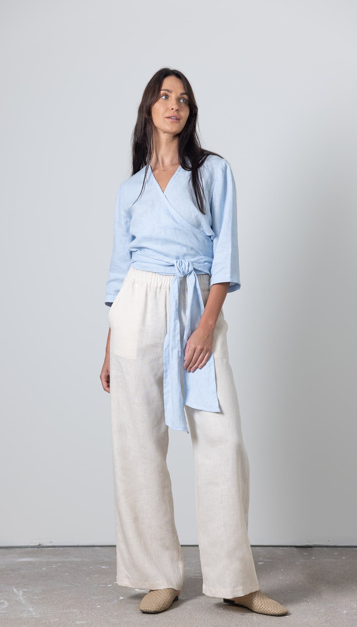 Women's blue linen wrap blouse Esmeralda with flattering V-neck and waist tie