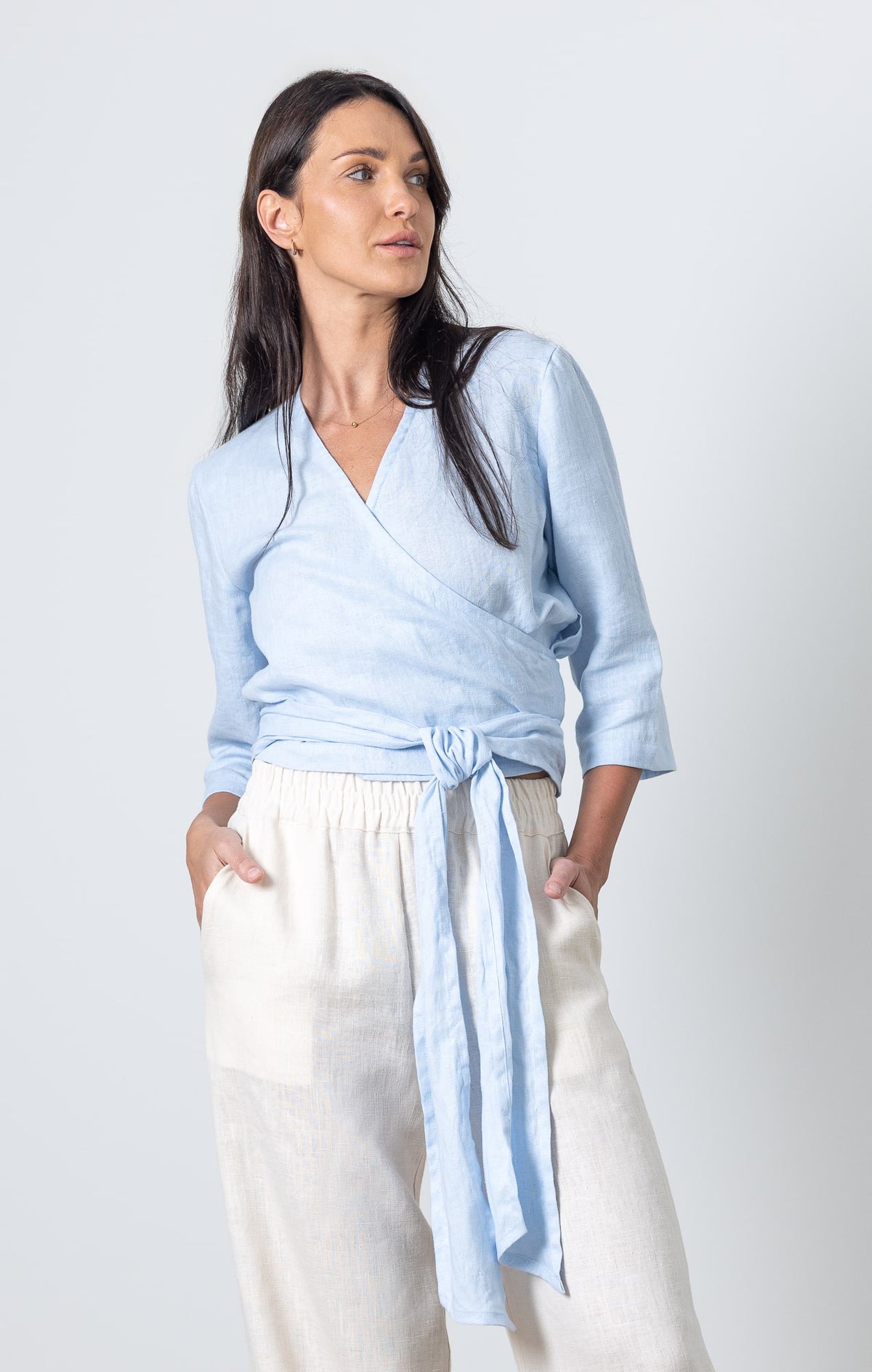Blue wrap top Esmeralda made of soft linen, styled with cream linen pants