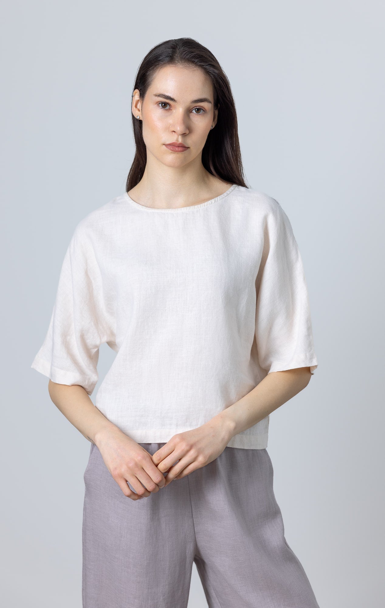 Model wearing White Linen Crop Top Molly, relaxed-fit linen top for women with short sleeves and round neckline