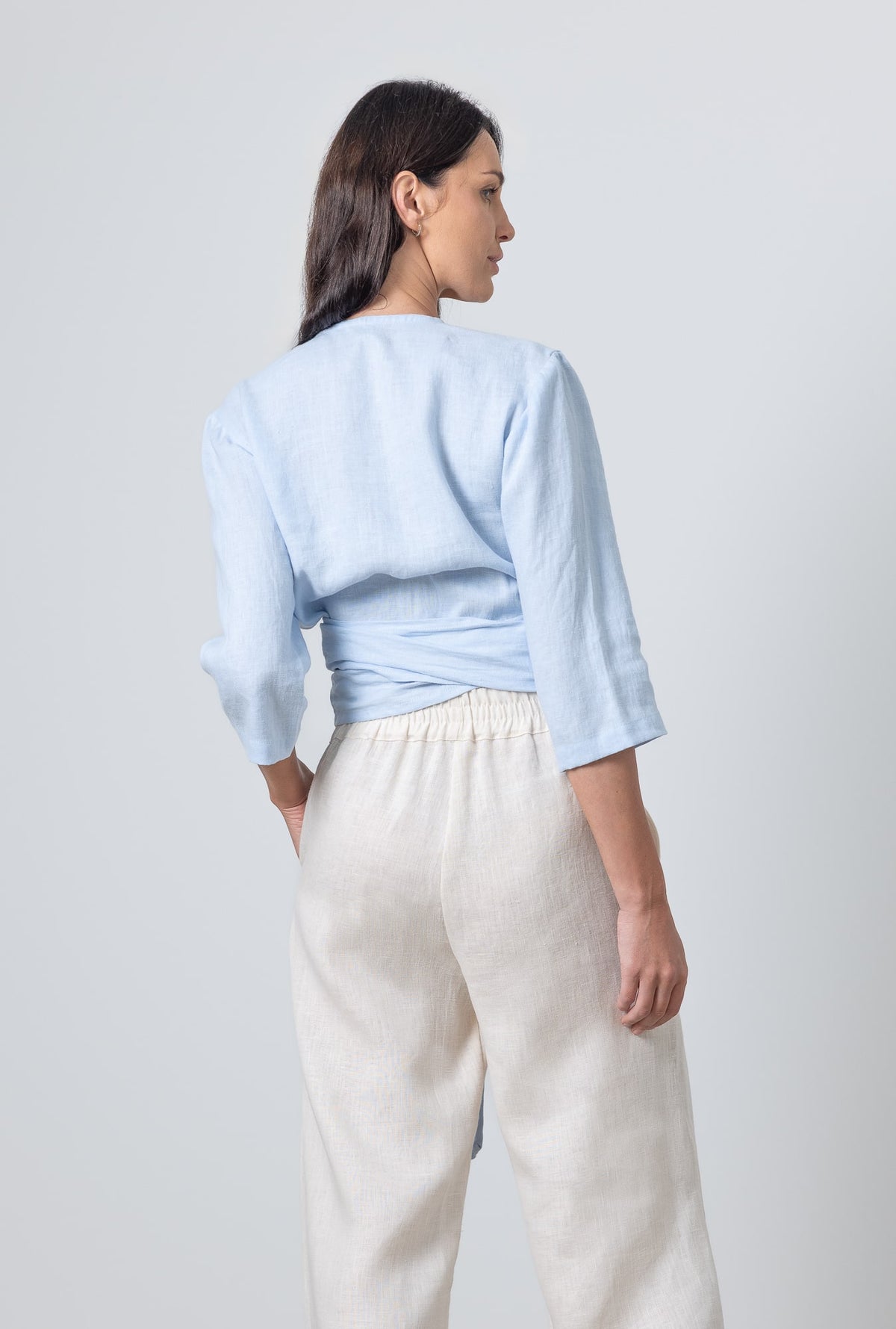 Light blue linen wrap blouse Esmeralda with cropped sleeves and adjustable tie
