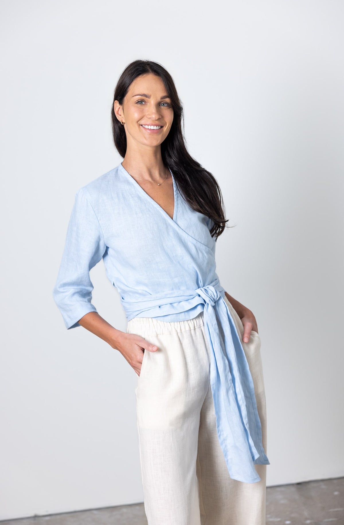Linen wrap top Esmeralda in light blue, featuring 3/4 sleeves and side tie