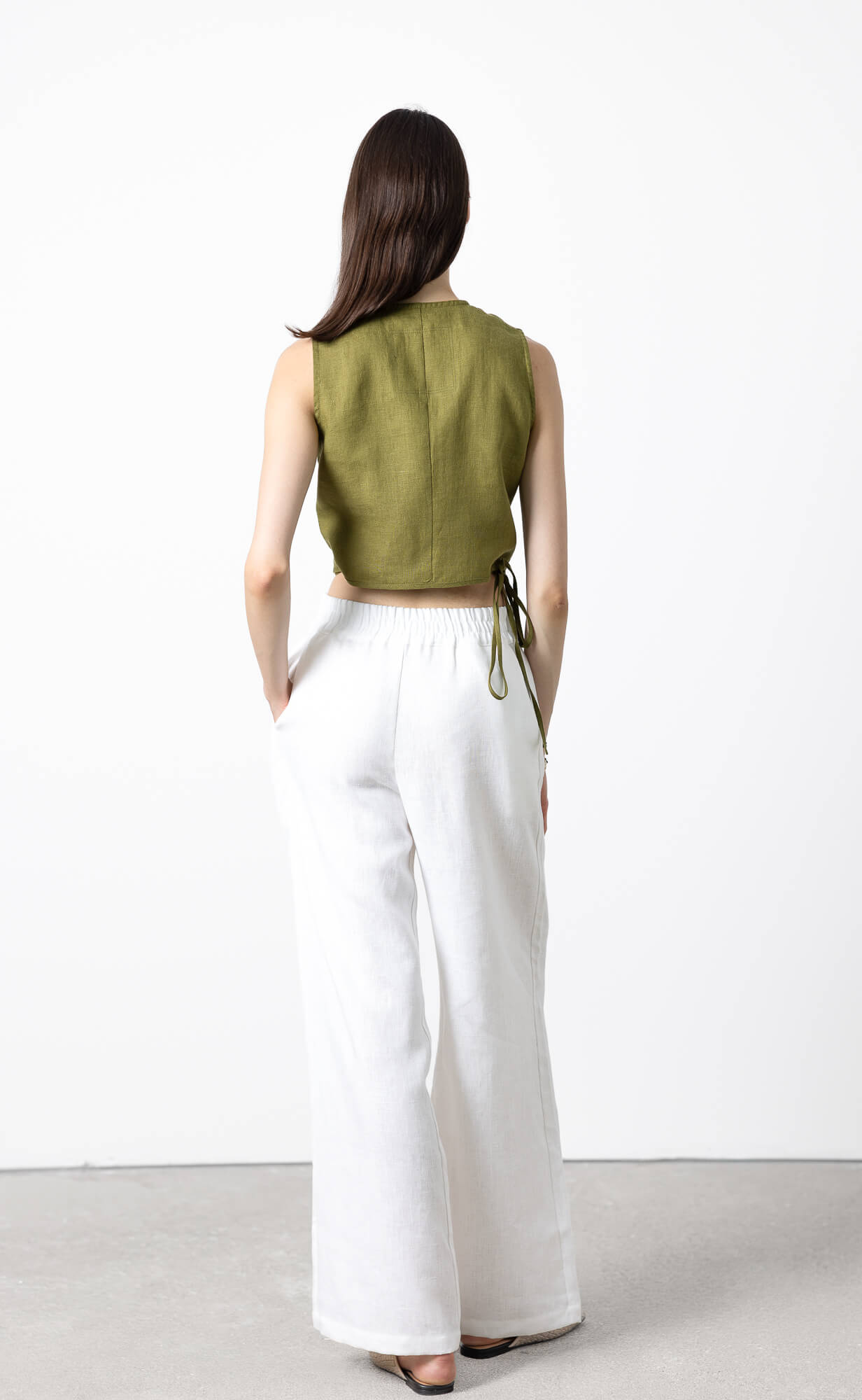 Back view of women's sleeveless linen wrap crop top with adjustable side tie, breathable lightweight OEKO-TEX® certified linen blouse for warm weather