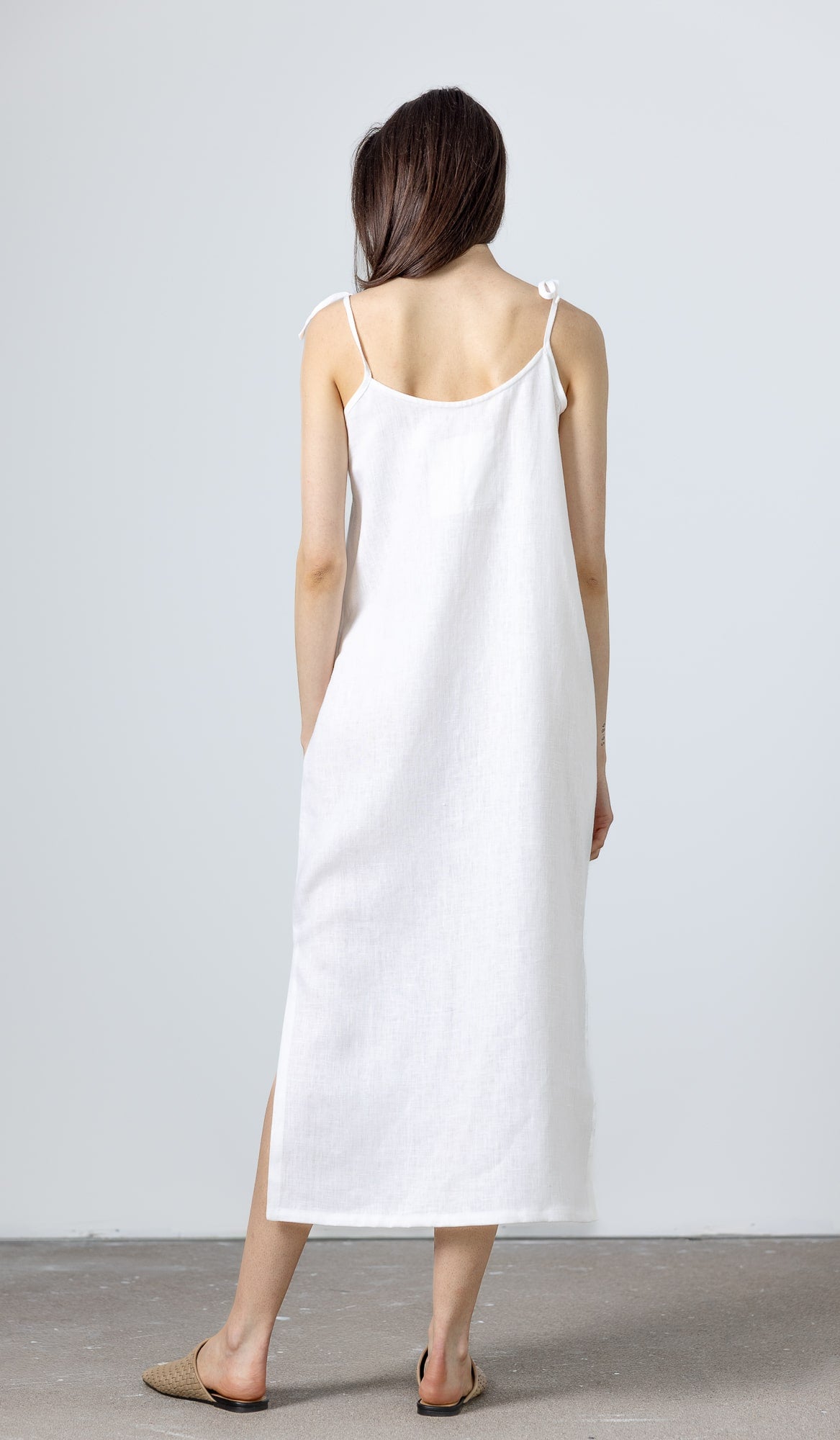 Back view of White Linen Slip Dress Monserrat by MINIMALISTICLINEN, a relaxed linen white dress crafted from sustainable fabric