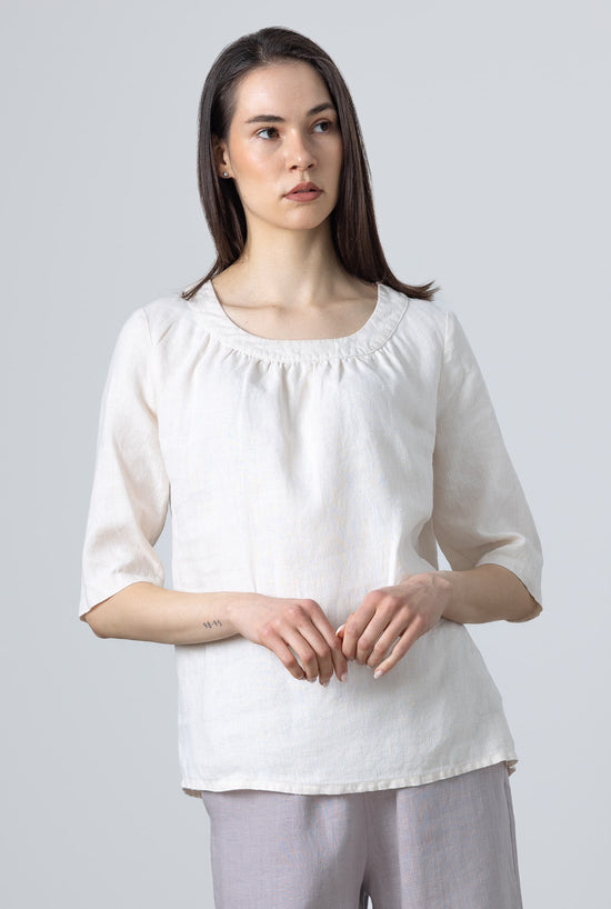 Close-up of Ladies White Linen Blouse Lily showing soft ruffle neckline and relaxed linen texture