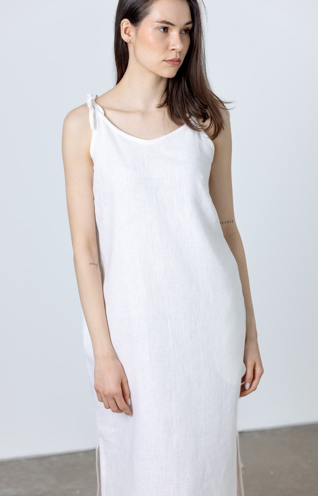 Front view of MINIMALISTICLINEN White Linen Slip Dress Monserrat — an elegant ladies white linen dress with a minimalist silhouette