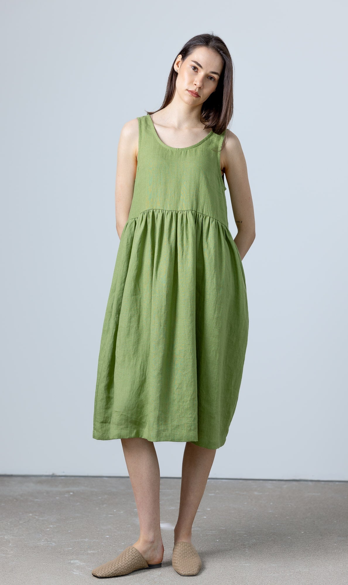 Front view of MinimalisticLinen midi green linen dress, the perfect everyday piece for minimalist wardrobes.