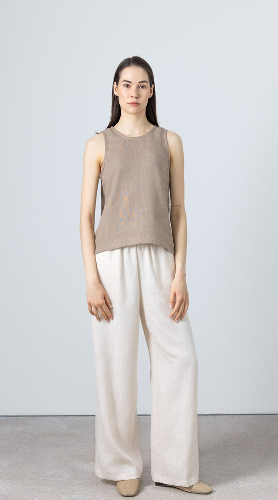 Sleeveless linen blouse for women – part of a minimalist capsule wardrobe, styled with wide-leg pants