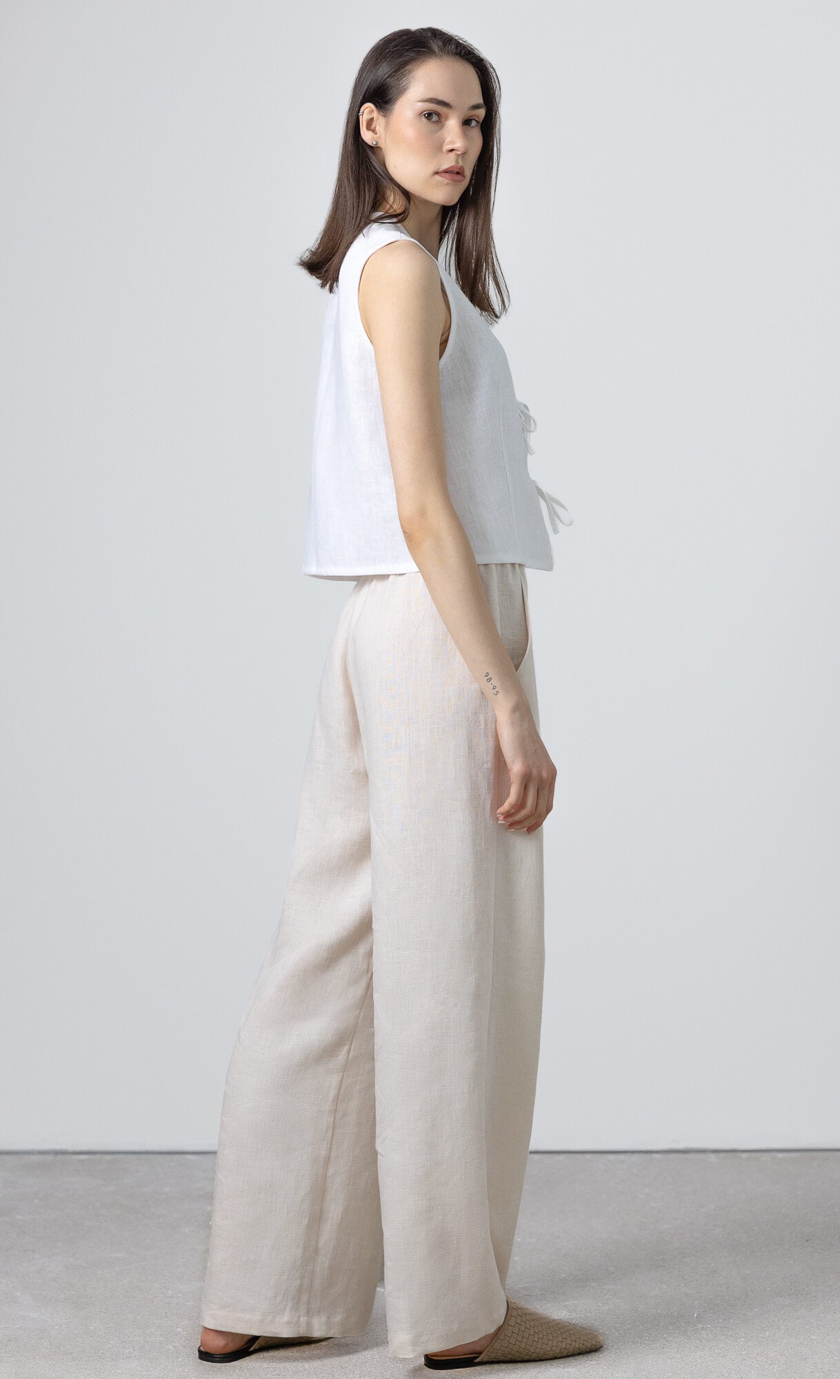 Women's linen trousers with relaxed wide leg fit and side pockets perfect for minimalist capsule wardrobe styling