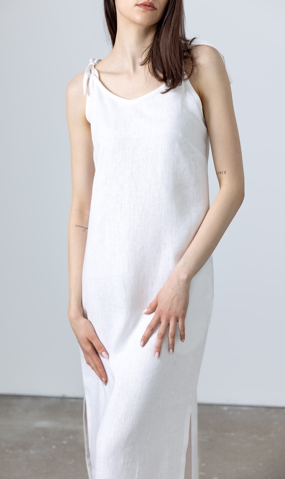 MINIMALISTICLINEN White Linen Slip Dress Monserrat styled with woven flats, showcasing a long white linen dress look with tie‑shoulder straps