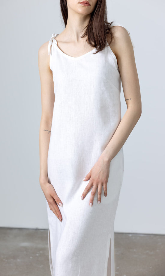 MINIMALISTICLINEN White Linen Slip Dress Monserrat styled with woven flats, showcasing a long white linen dress look with tie‑shoulder straps