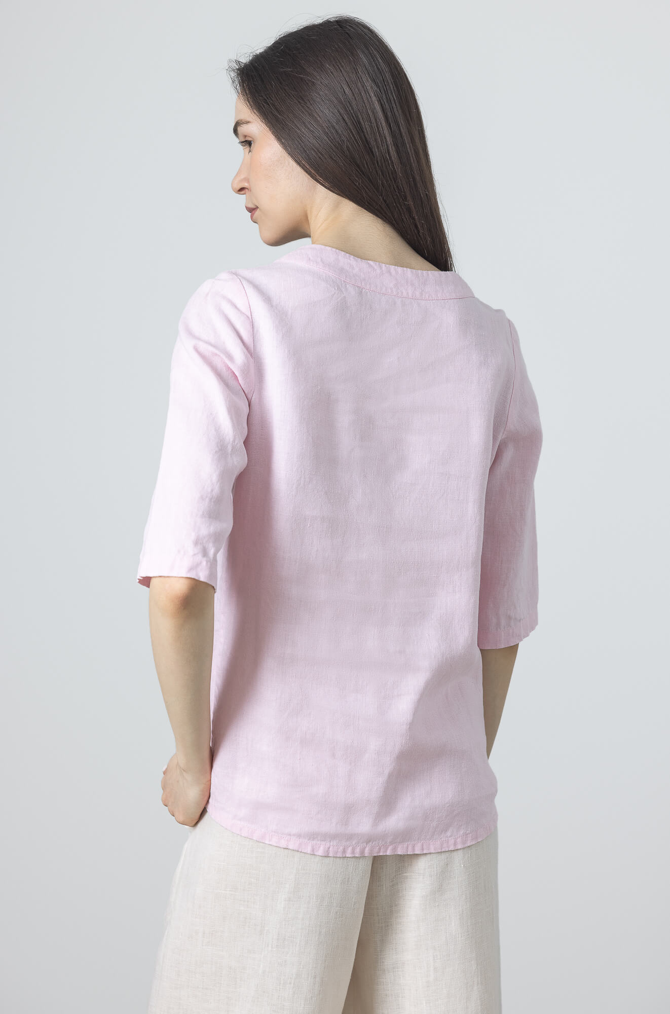 Minimalist blush pink linen blouse made from breathable linen with relaxed everyday styling.