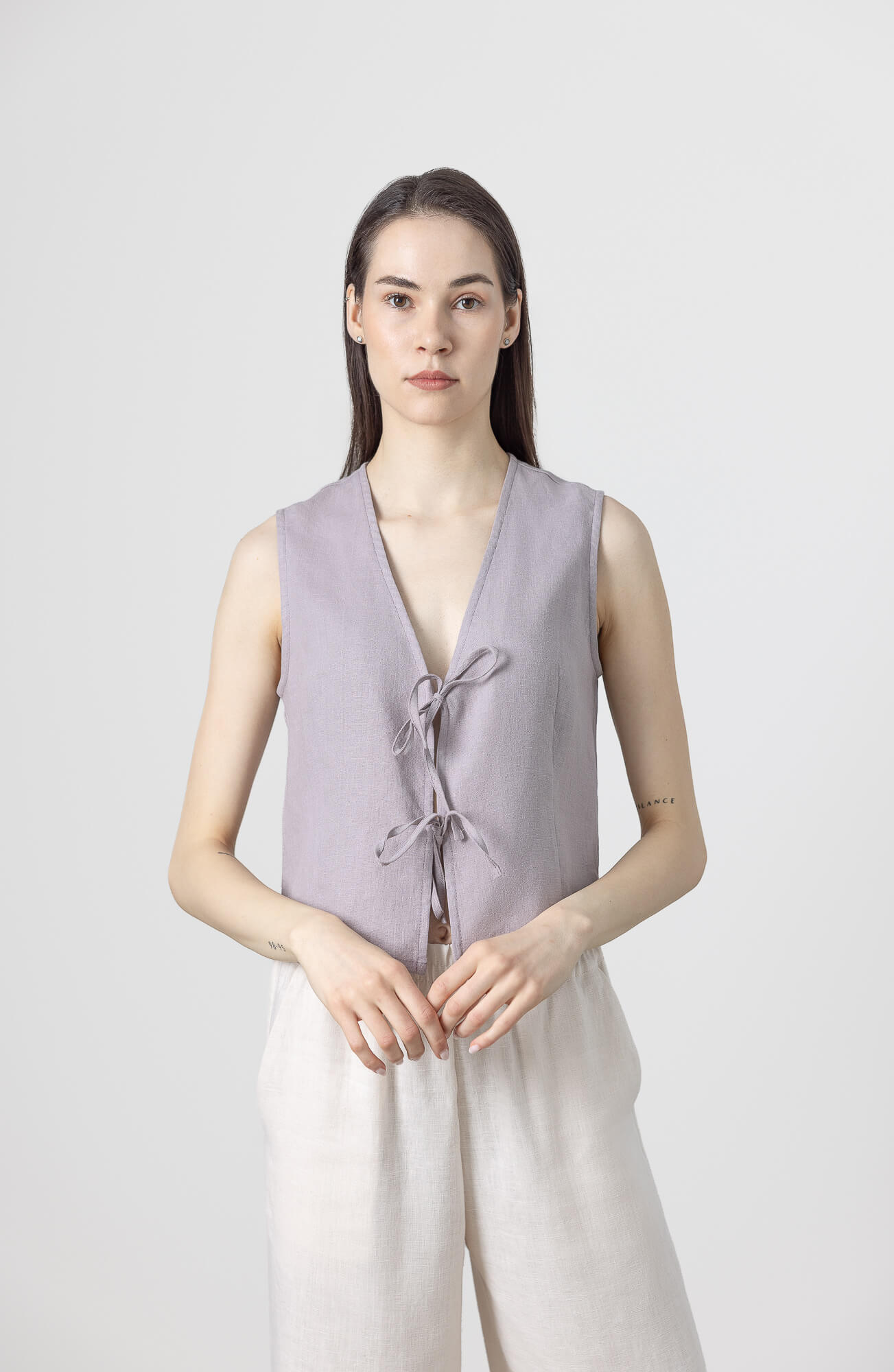 Minimalist linen vest top with sleeveless cut and front bow tie details