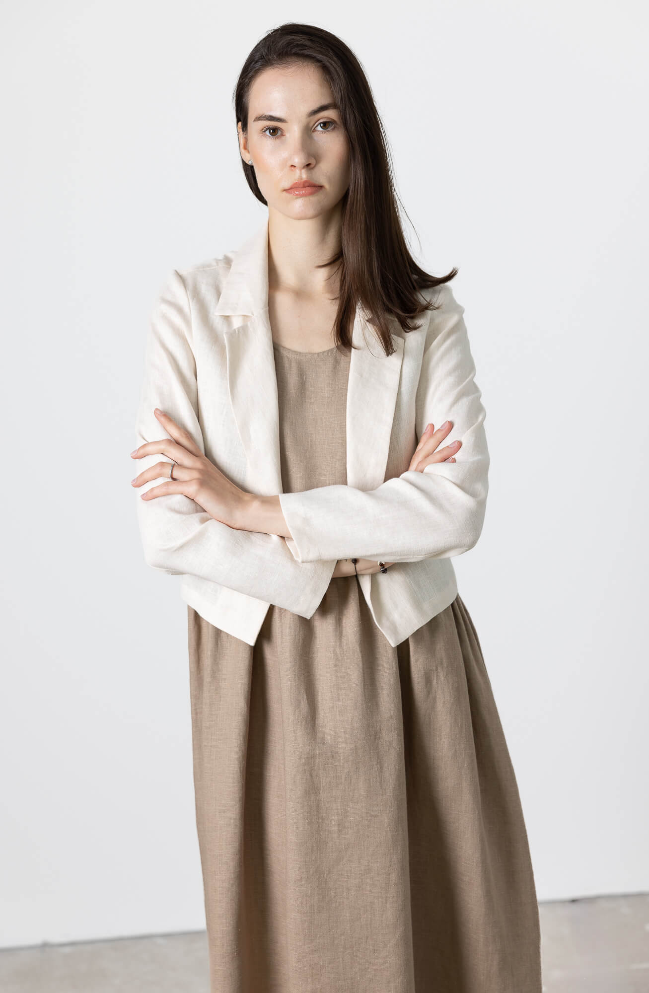 Minimalist women’s linen cropped jacket in neutral beige color