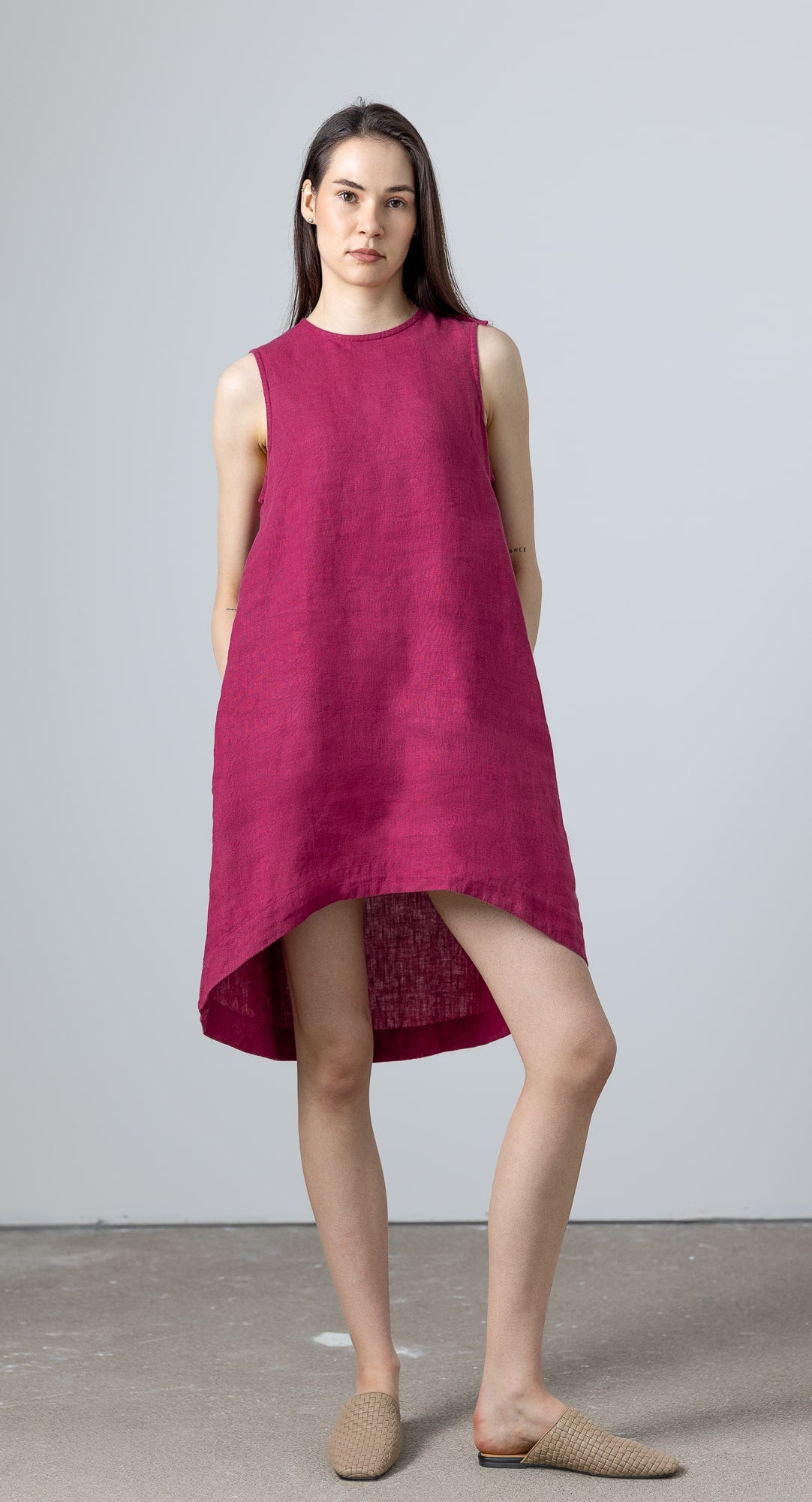 Model wearing sleeveless purple linen shift dress