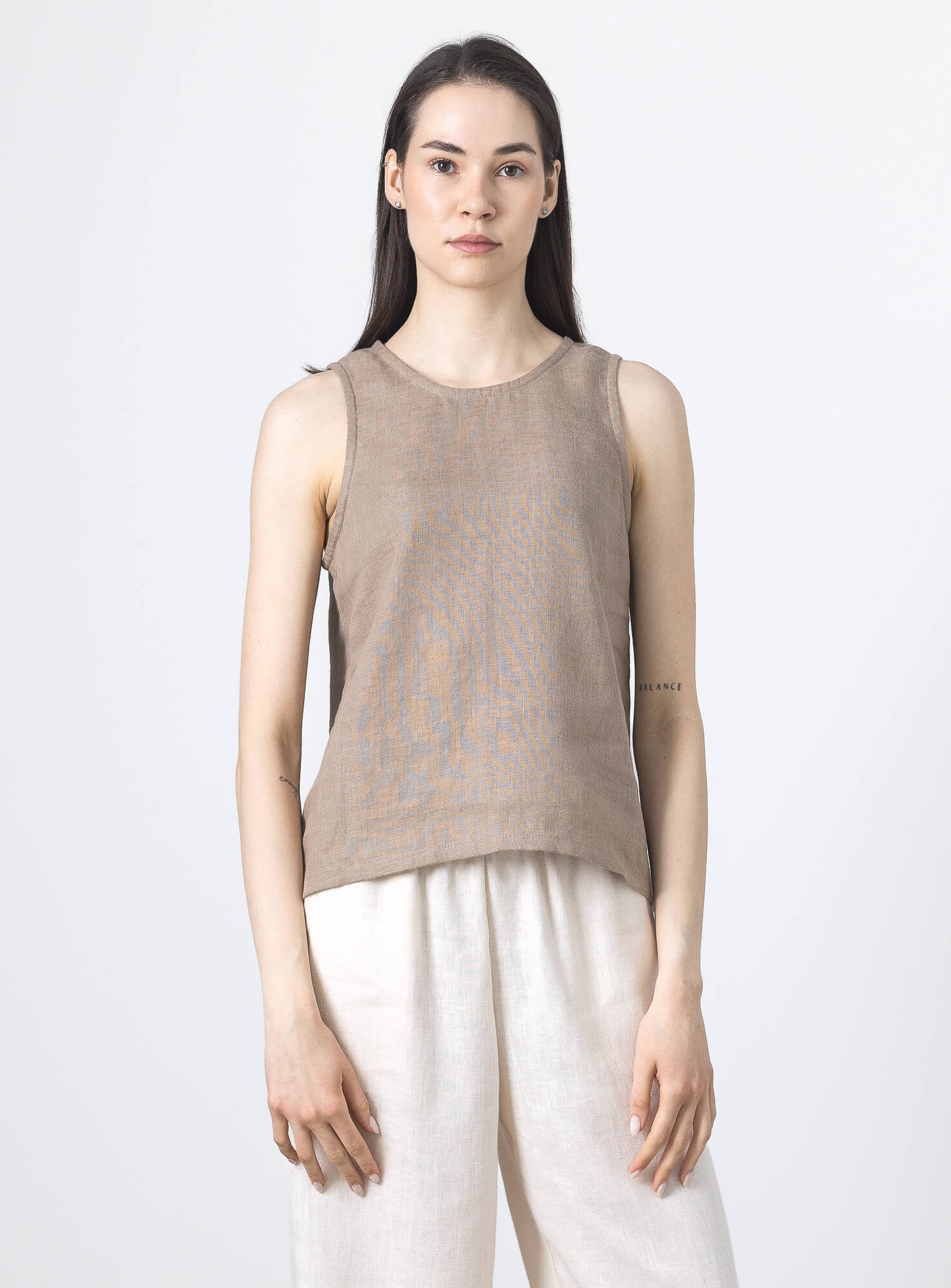 Women's taupe linen sleeveless blouse with a relaxed minimalist fit and round neckline.