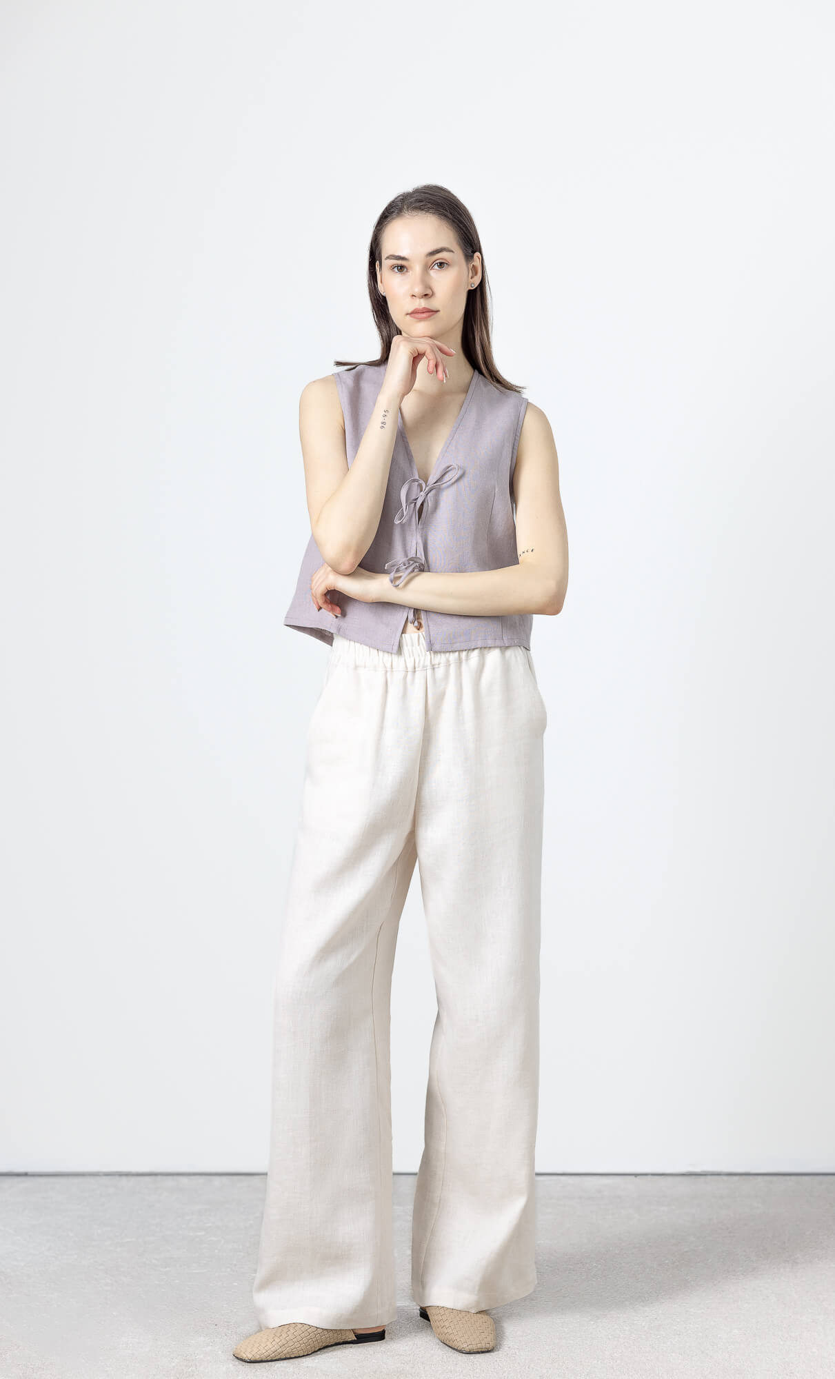 Women's linen vest top featuring a sleeveless silhouette and adjustable front ties