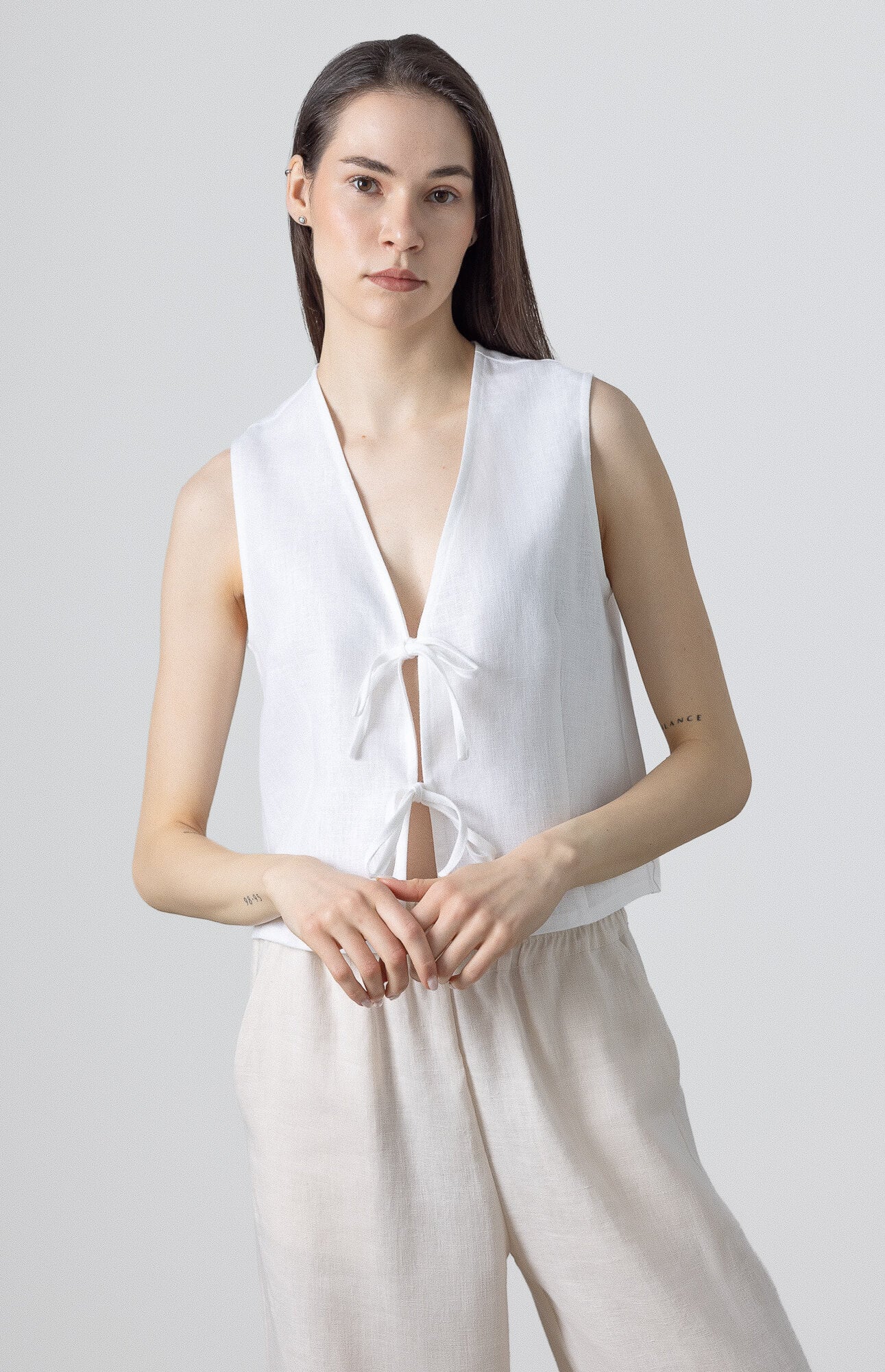 Natural linen vest styled with matching relaxed linen pants for an effortless everyday outfit