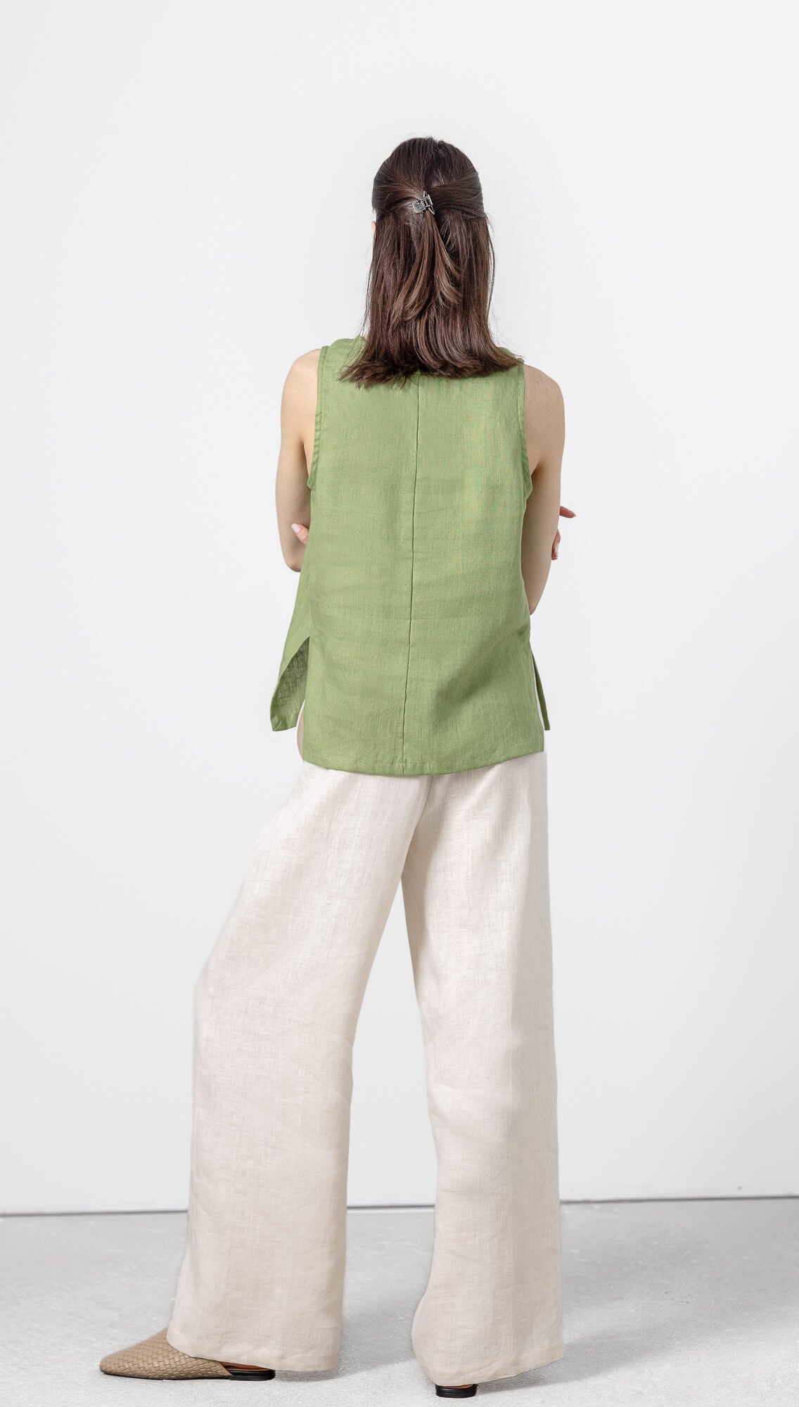 Women's olive green sleeveless linen blouse with relaxed fit and minimalist style.