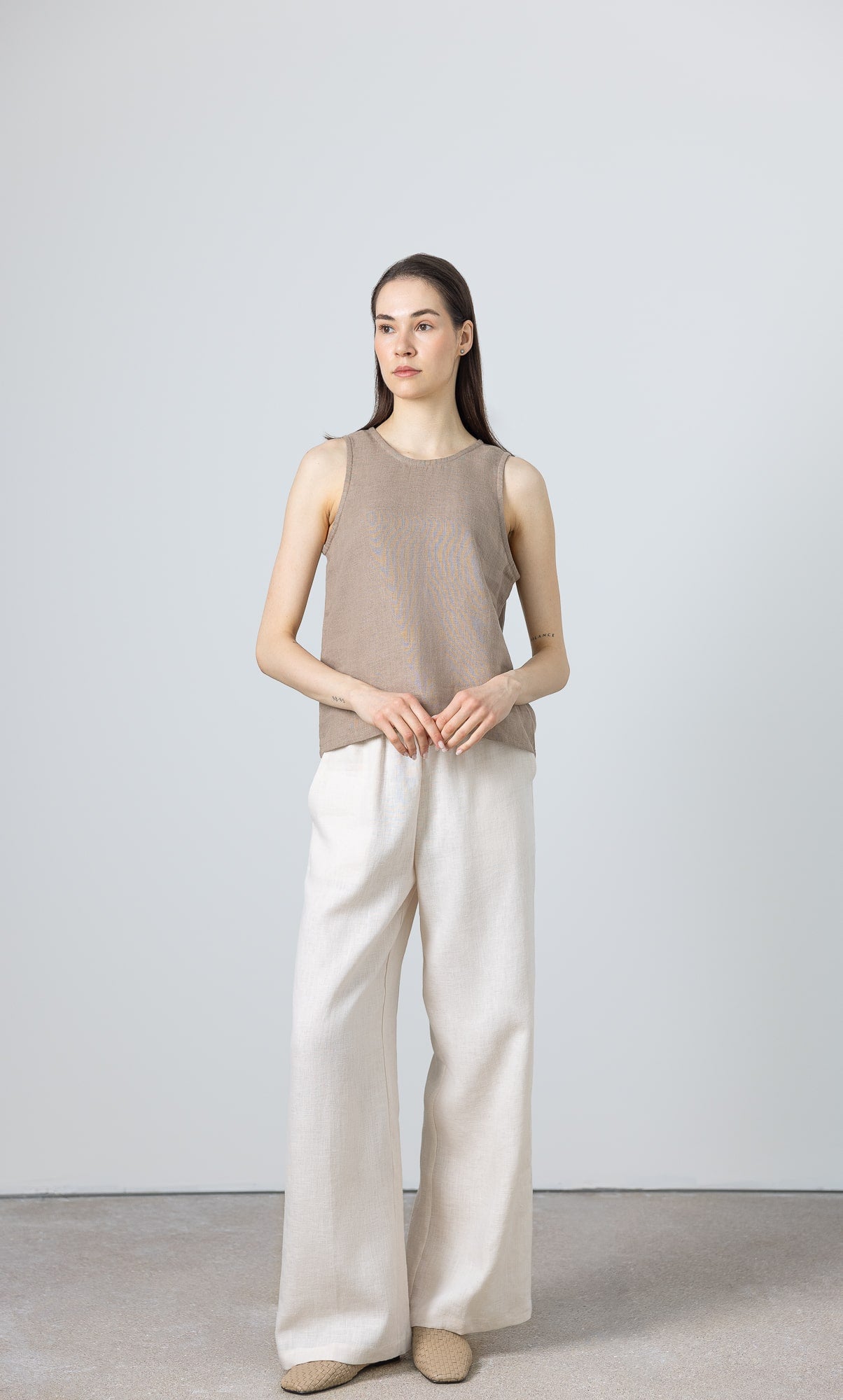 Minimalist linen tank top for women – sleeveless cut, laid flat to show shape and craftsmanship