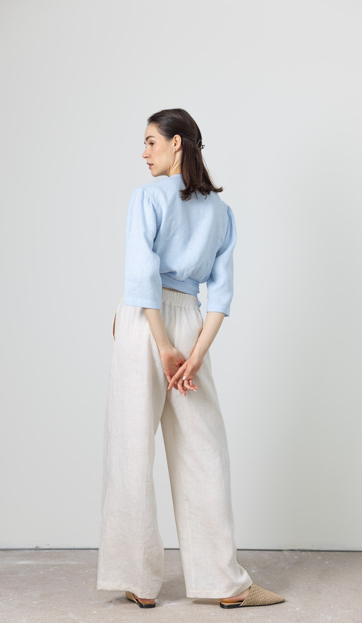 Soft blue women's linen wrap top styled with wide-leg linen pants – breathable and stylish set
