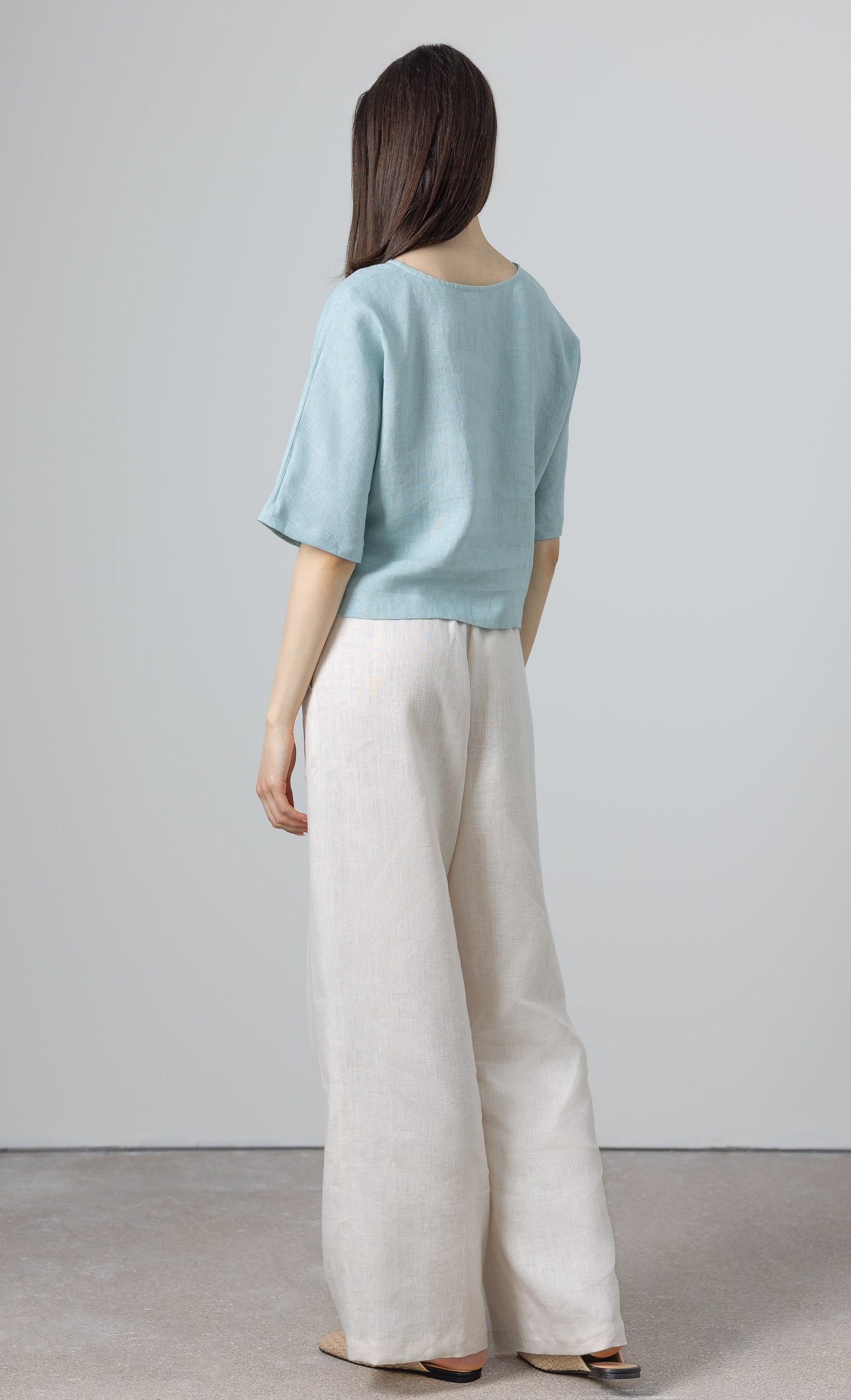 Back view of linen crop top for women – light blue minimalist blouse in natural fabric