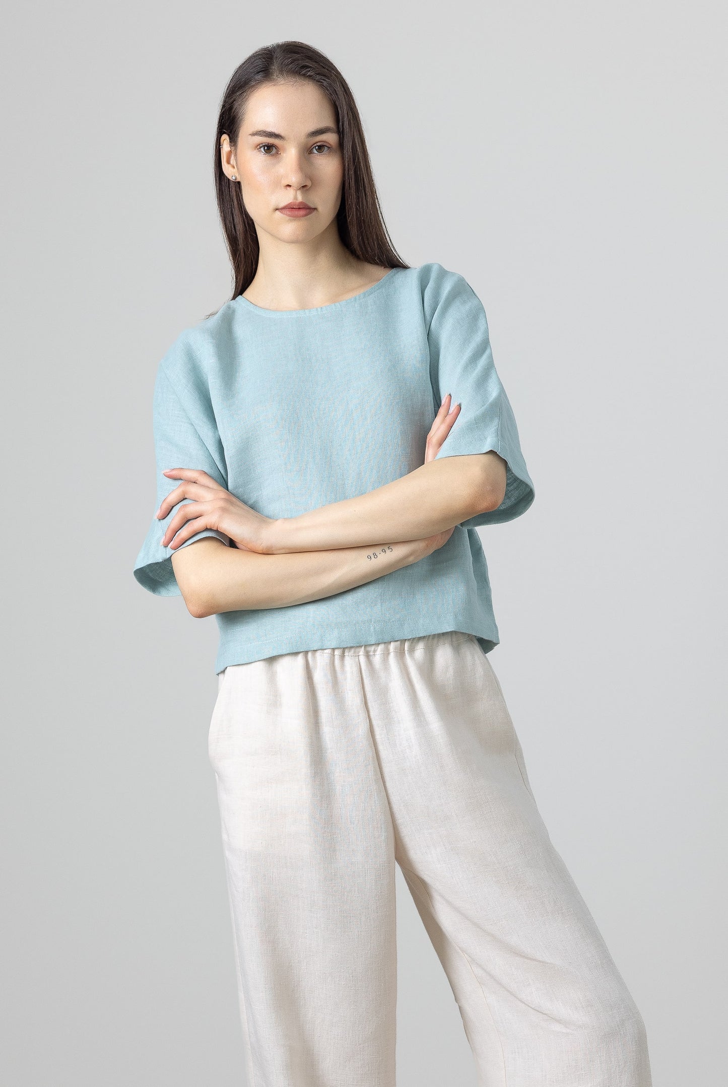 Linen cropped top in pastel blue – relaxed short-sleeve blouse for women