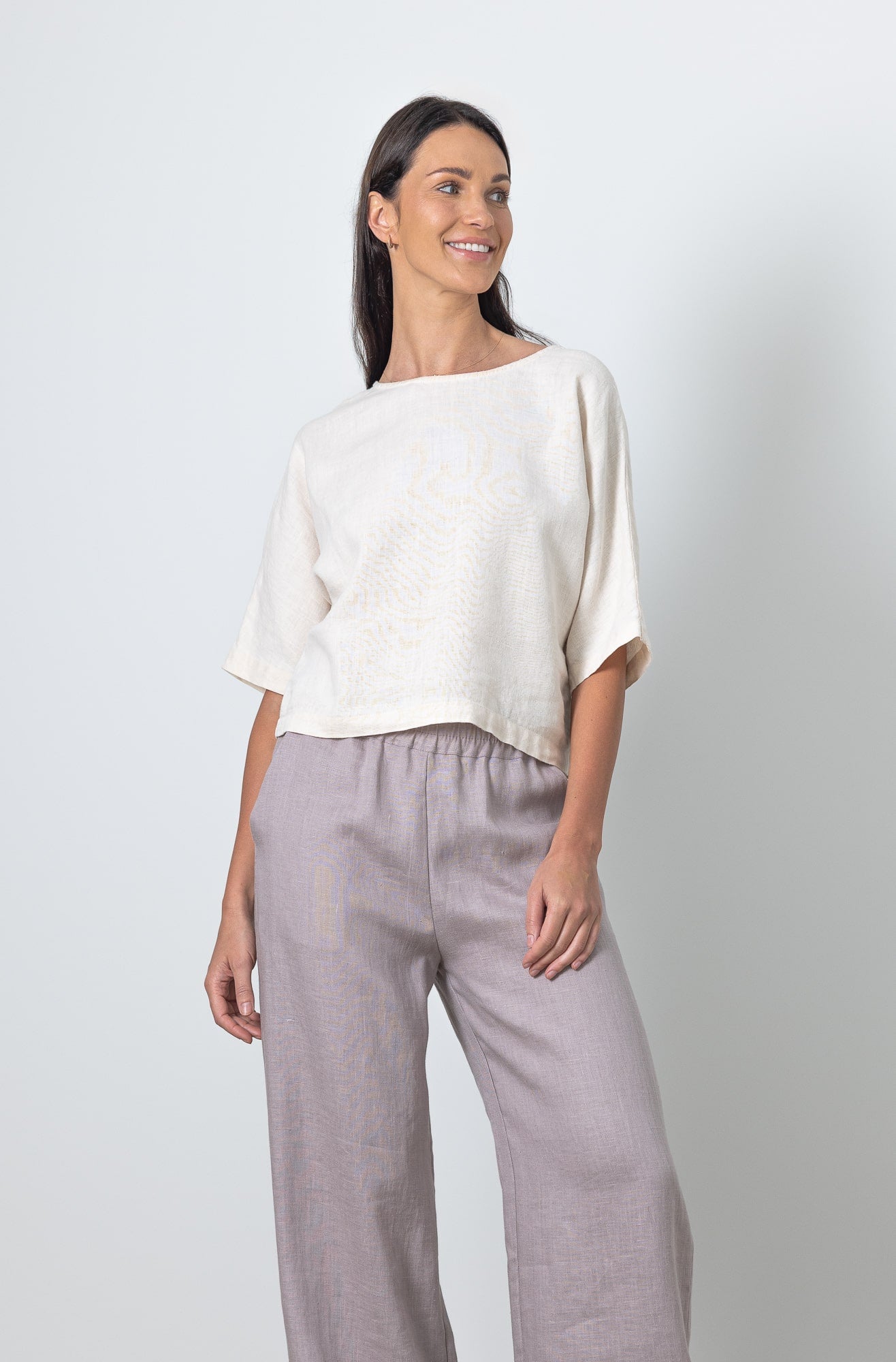 Woman wearing MOLLY linen crop top paired with wide leg linen pants, minimalist summer outfit