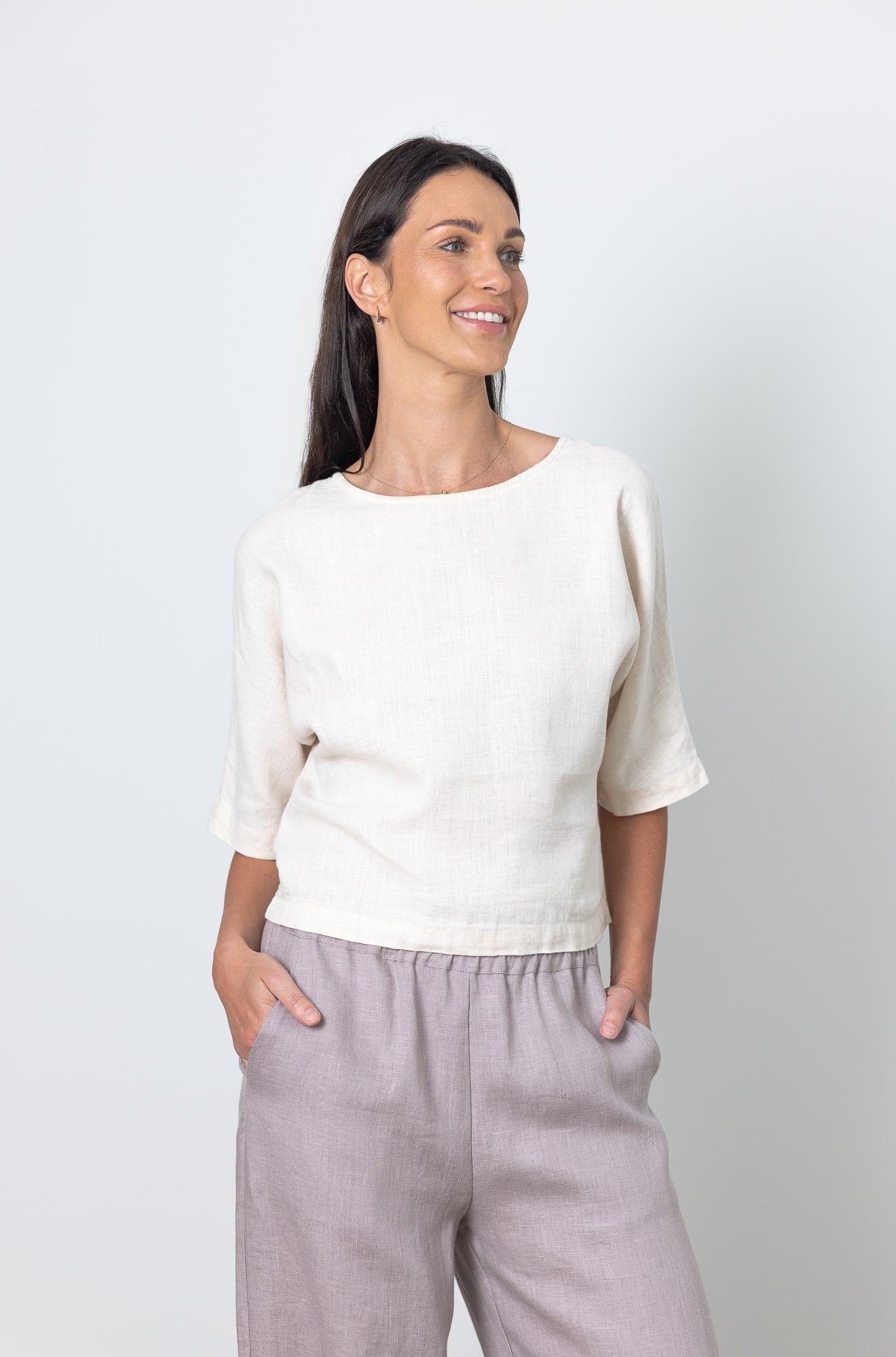 Model wearing boxy linen crop top and high-waisted wide leg linen pants, timeless capsule wardrobe look