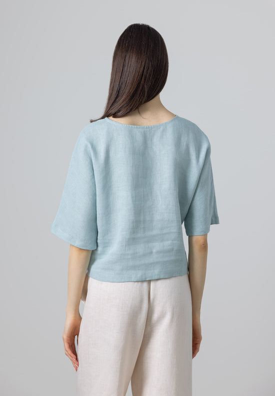 Rear view of linen cropped top – light blue blouse for women in breathable fabric