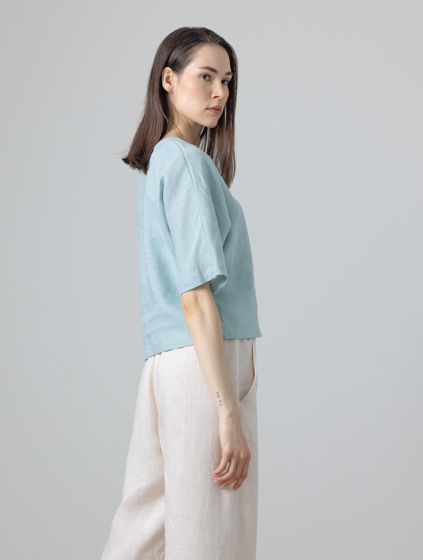 Side view of linen blouse for women – light blue cropped top in breathable linen
